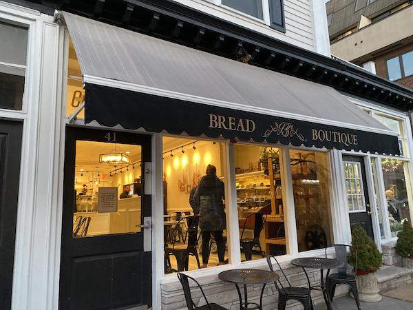 Outside a bread boutique store looking into a warm and yellow lighting atmosphere.