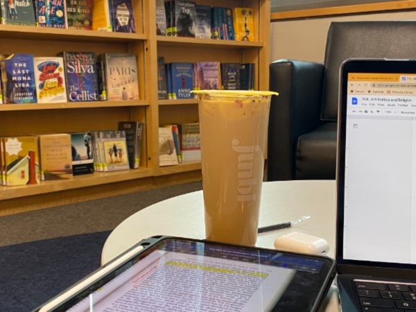 Photo of Junbi coffee on a library table alongside student work.