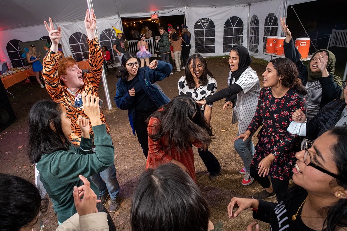 Group of students dancing in a circle